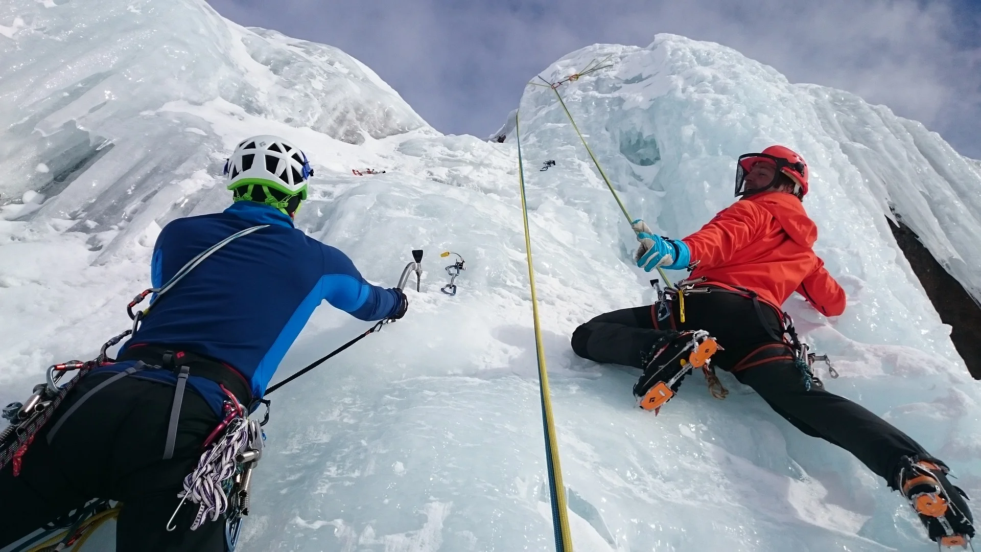 Two people climbing ice face