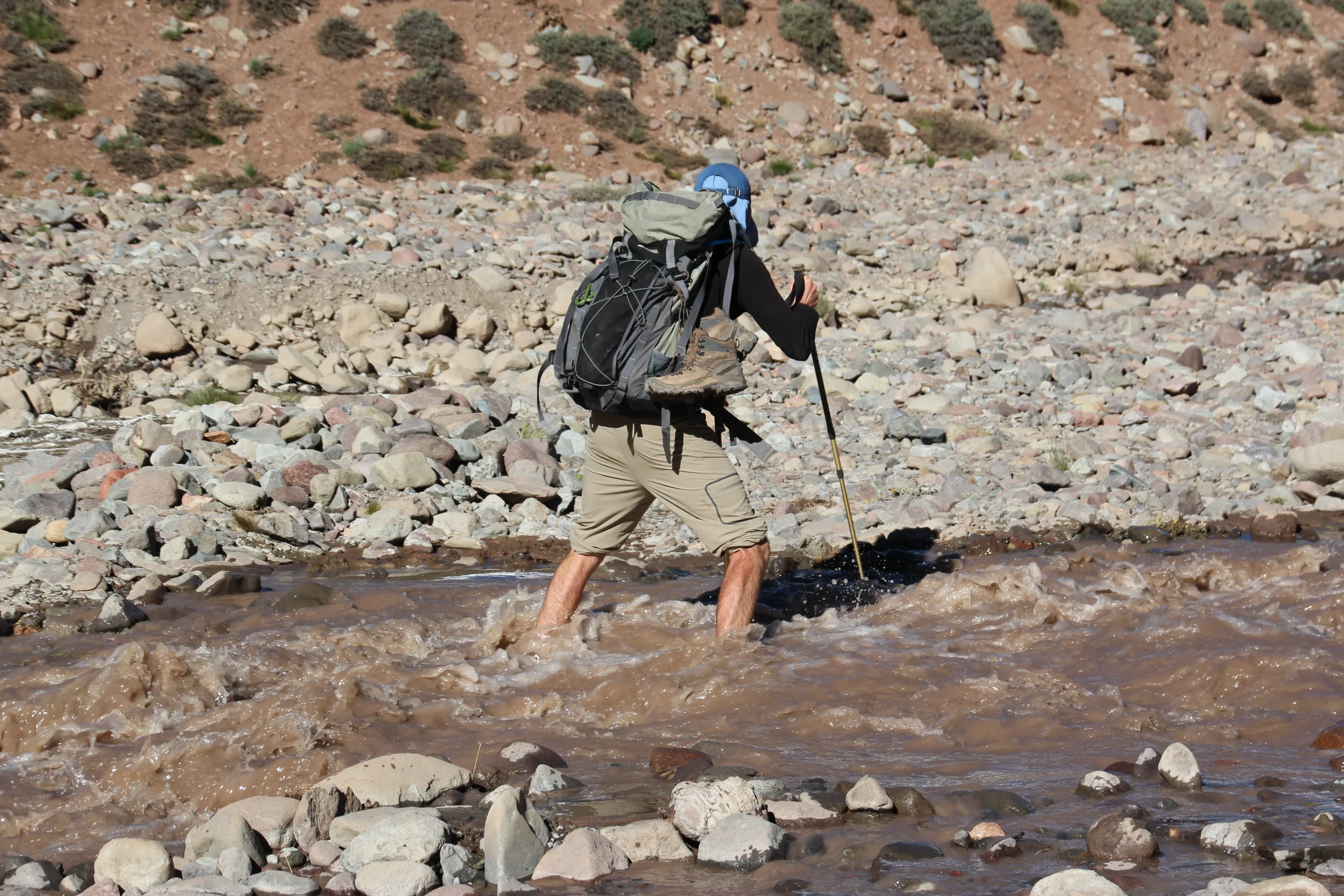 Logan crossing river on Aconcagua