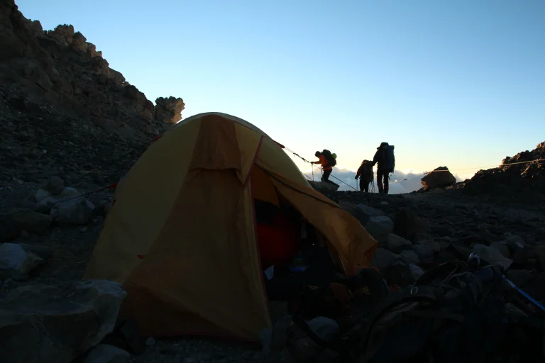 Dusk photo of climbing away from tents