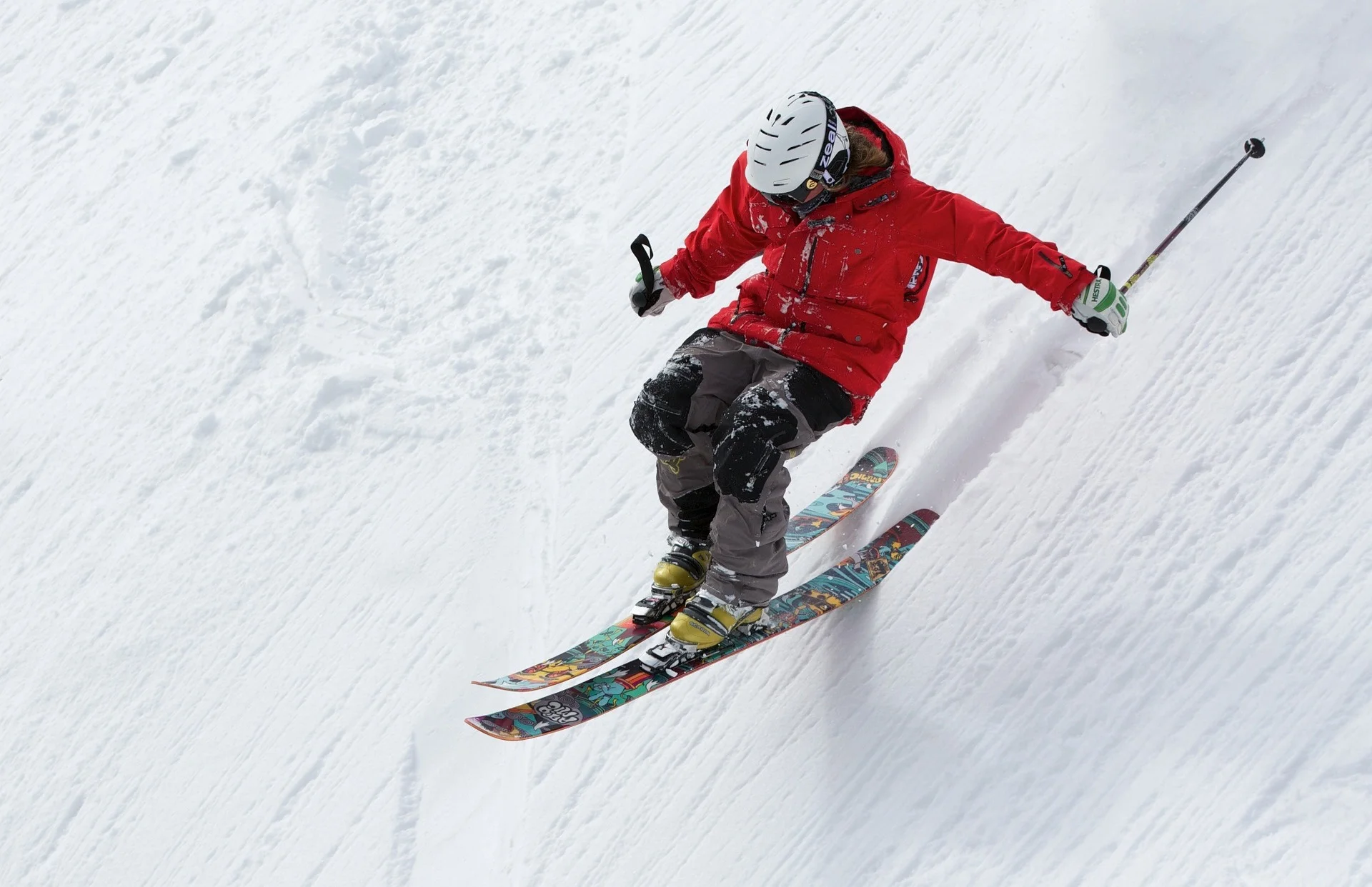 Man skiing down steep slope