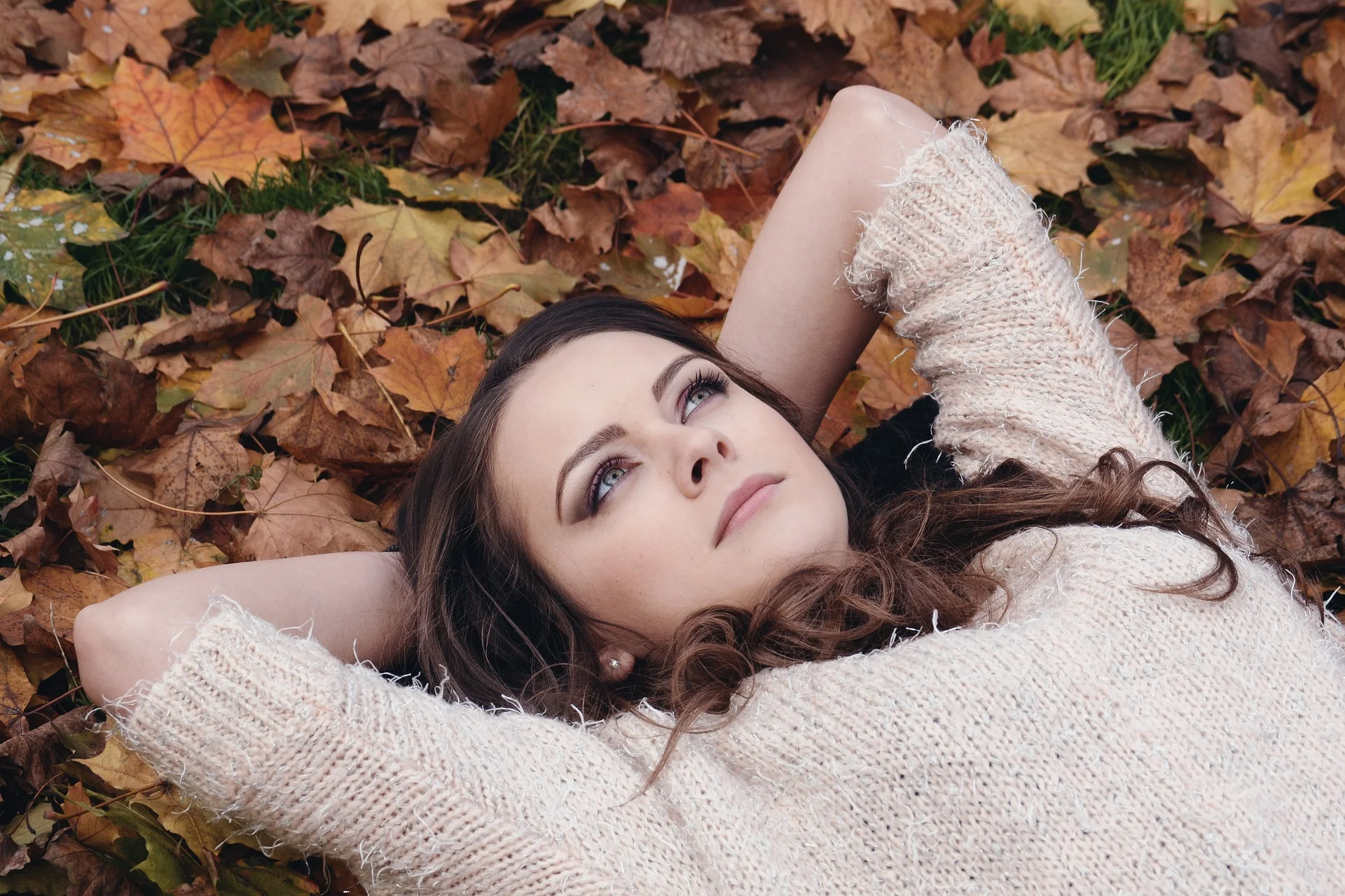 Girl laying in leaves reflecting on self-awareness